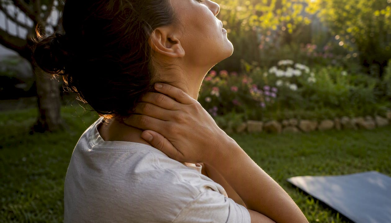 Hands supporting neck in cervical extension stretch