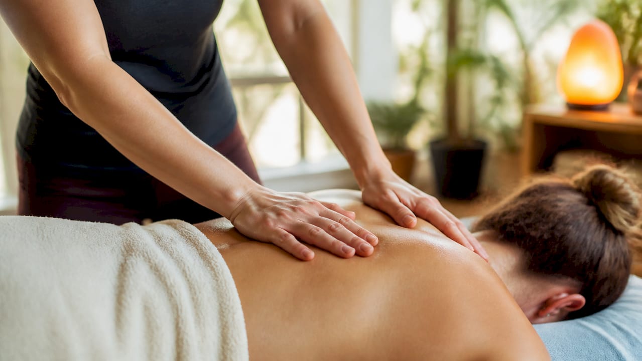 Therapist massaging neck and shoulder muscles
