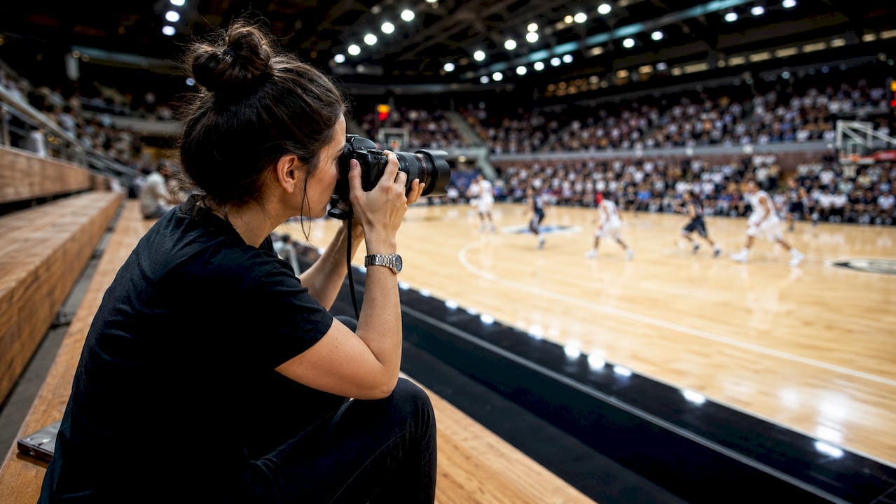 Photographer holding high-speed camera indoors