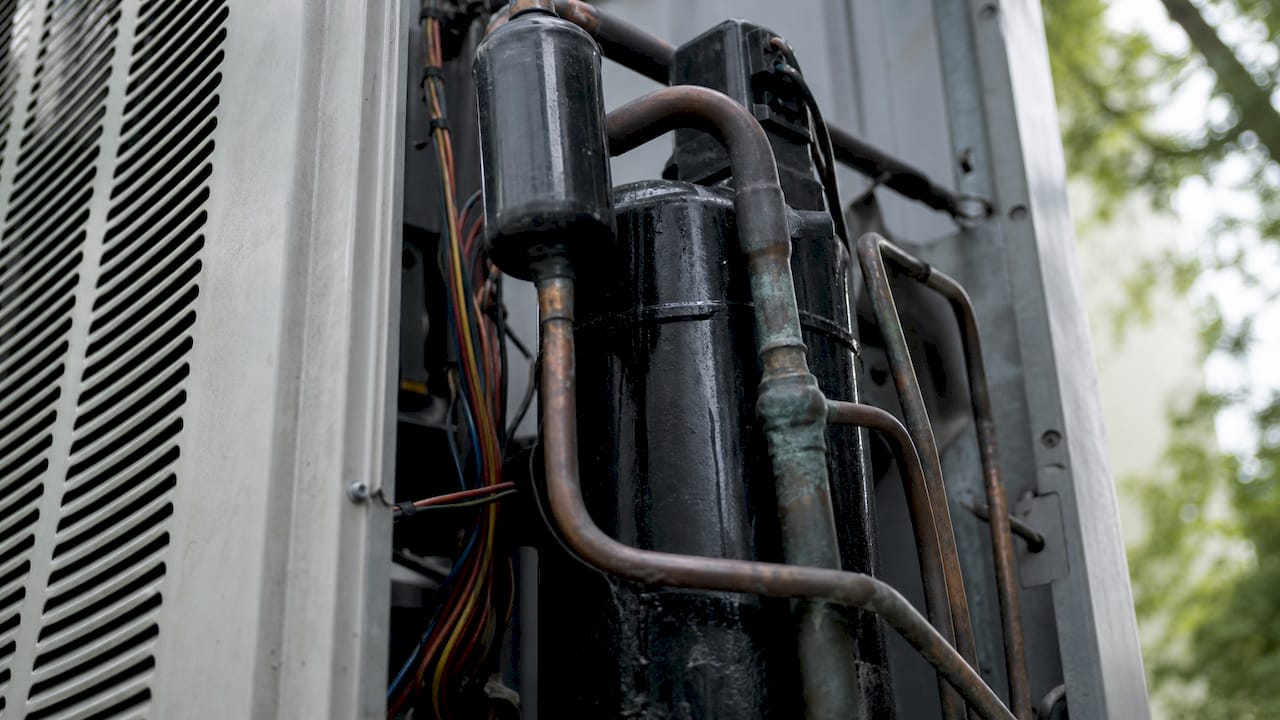 Close-up of AC compressor mechanical parts outdoors