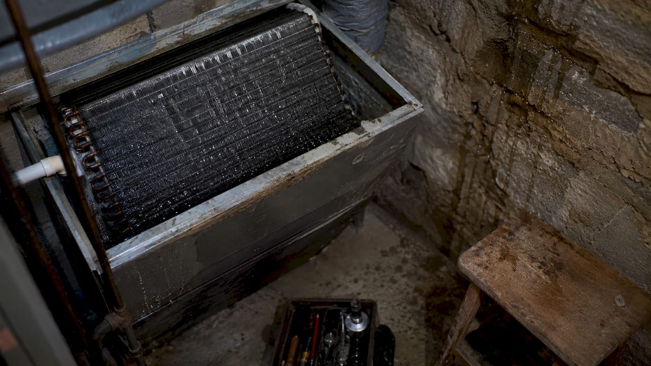 Close-up view of AC evaporator coil with condensation