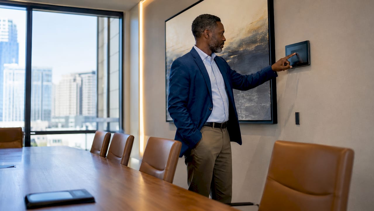 Man interacting with office HVAC control panel