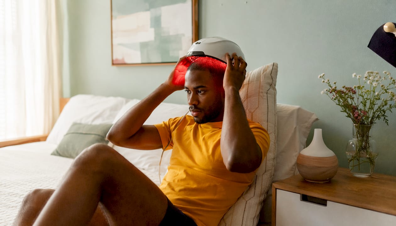 Man using red light therapy for hair growth