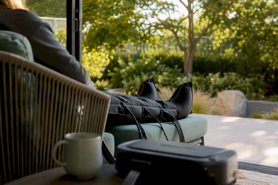 Person wearing intermittent pneumatic compression boots