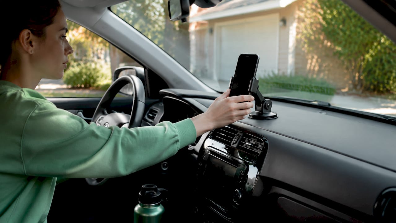 Close-up of smartphone being mounted inside car