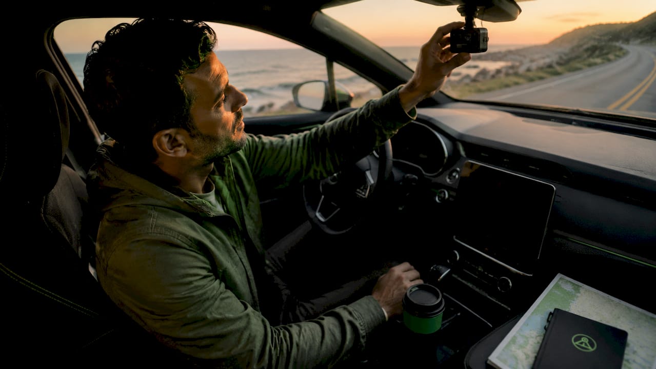 Driver recording dashcam hyperlapse footage inside car