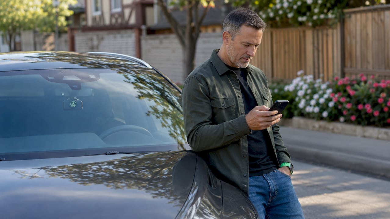 Man checking dashcam alert notification on phone