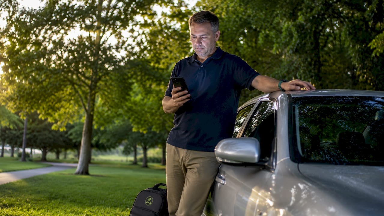 Car owner reviewing parking alert on smartphone