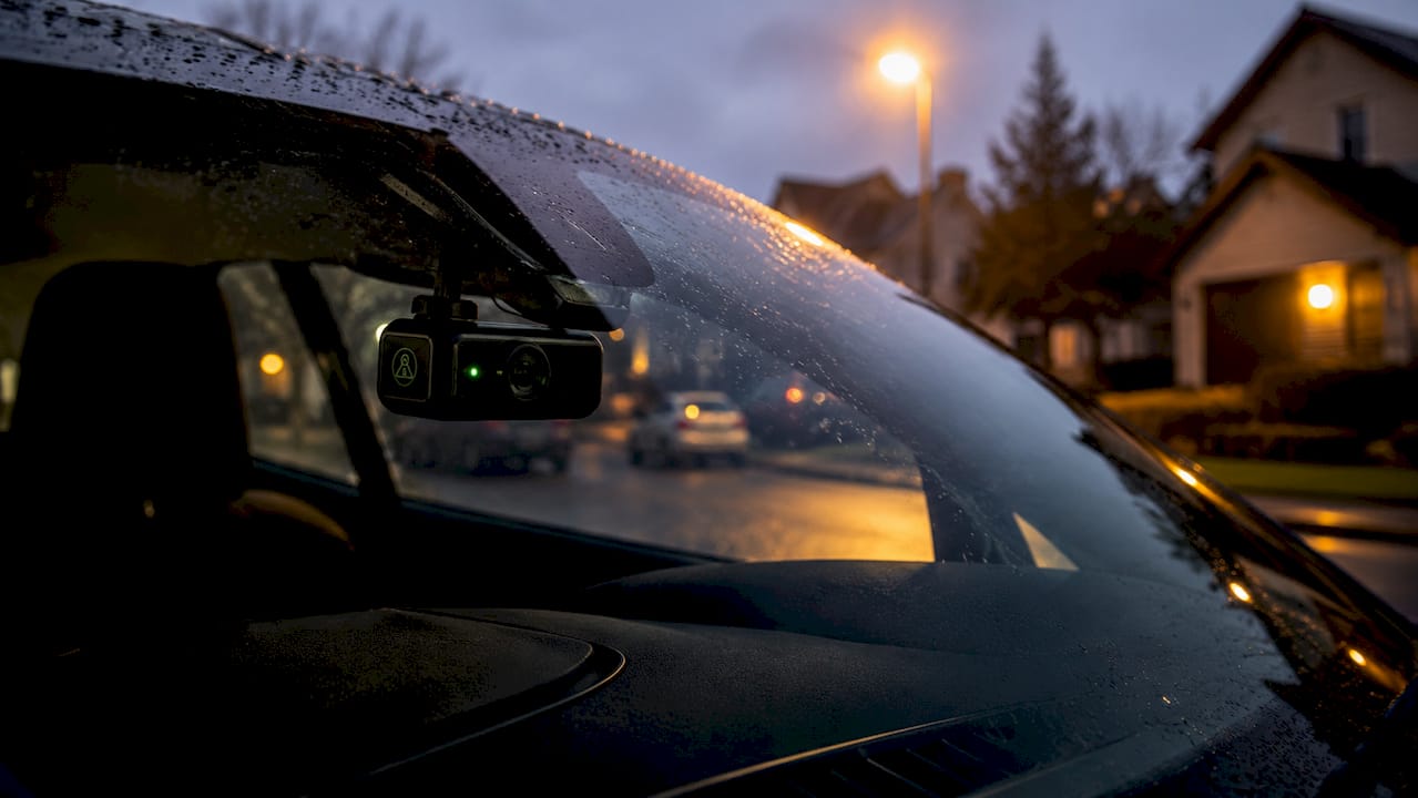Close-up of dashcam in parked car windshield