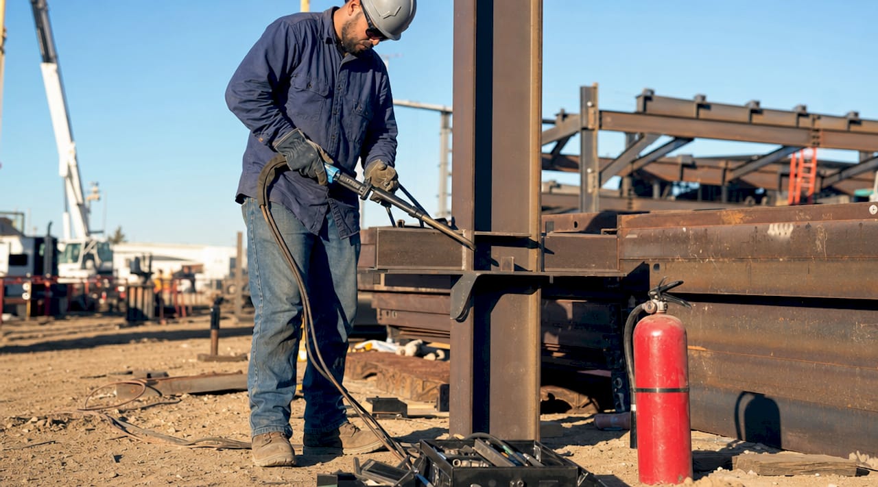 The Role of SCDF in Construction: 2026 Compliance Guide Hands holding welding tool near construction screening net