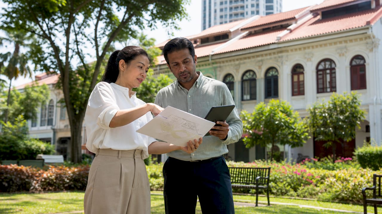 Professionals inspecting shophouse redevelopment site