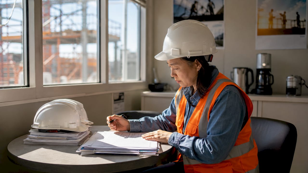Site safety manager reviewing operational controls documents