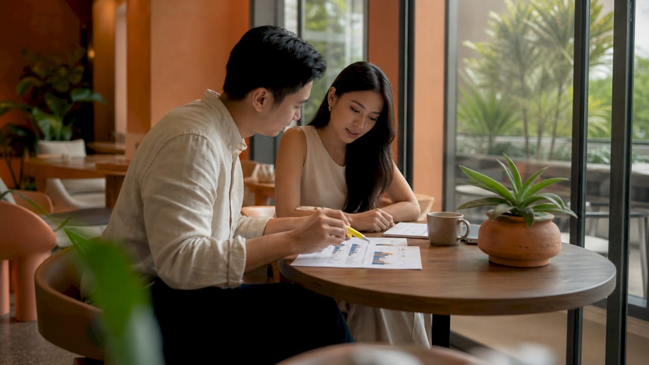 Couple discussing financial details in condo sales office