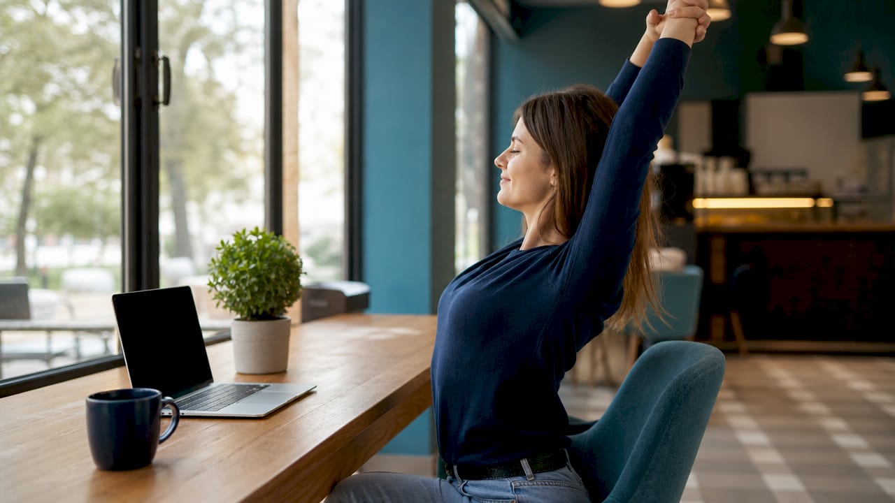 Desk worker doing seated arm stretch exercise