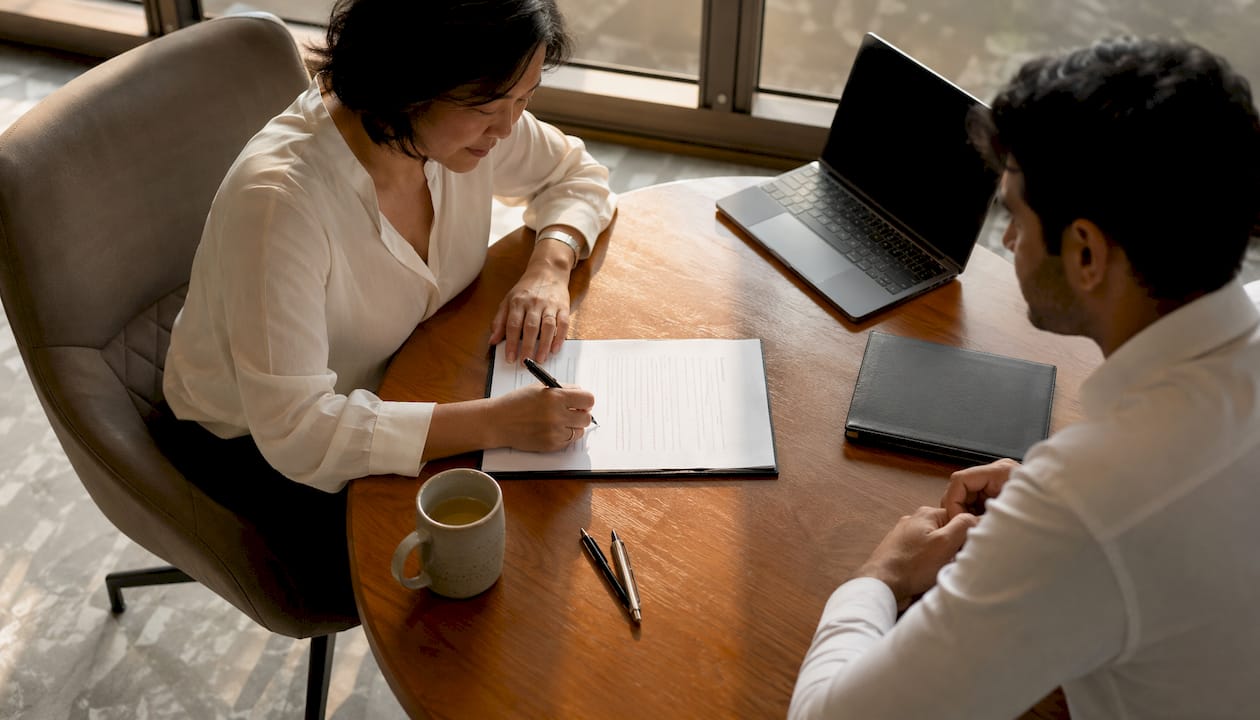 Owner signing collective sale agreement in meeting