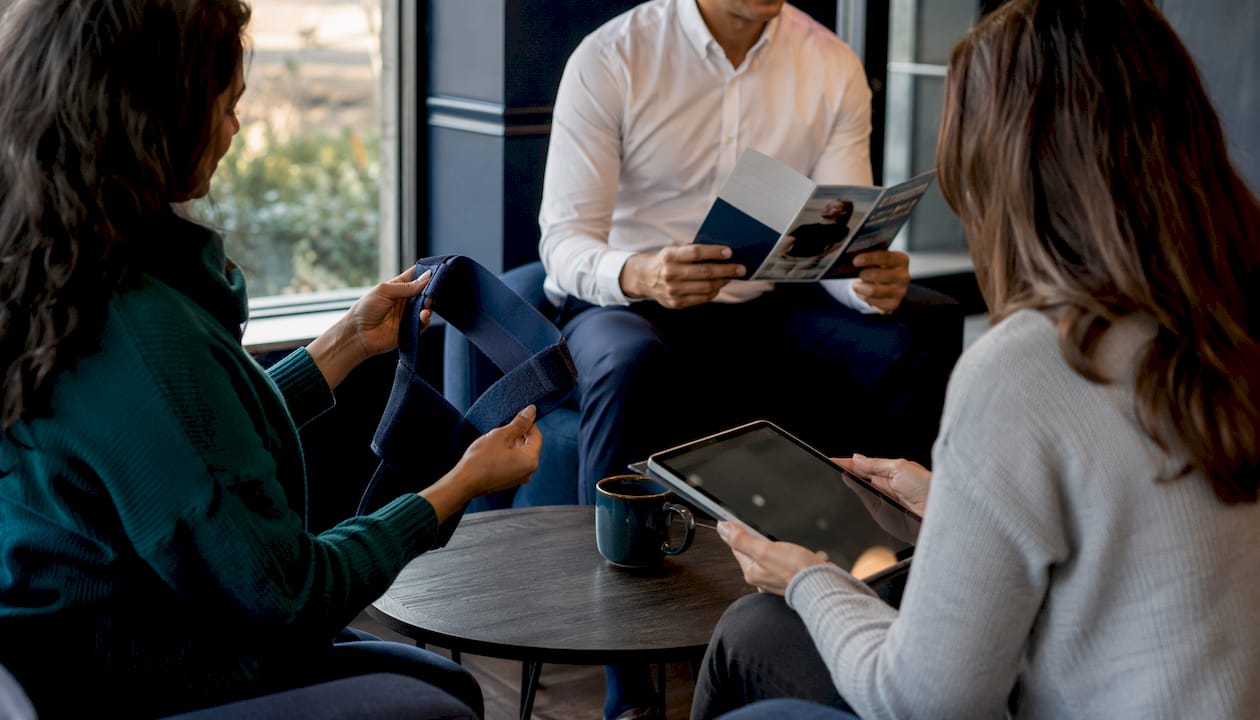Patients reviewing posture care devices in clinic