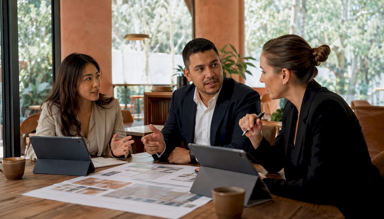Diverse team collaborating on real estate investment plans