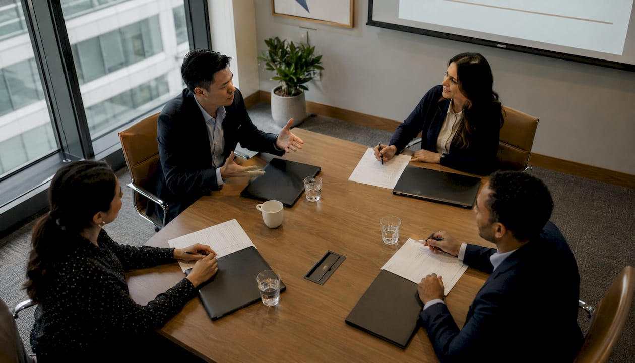 Audit team holding pre-meeting discussion at table