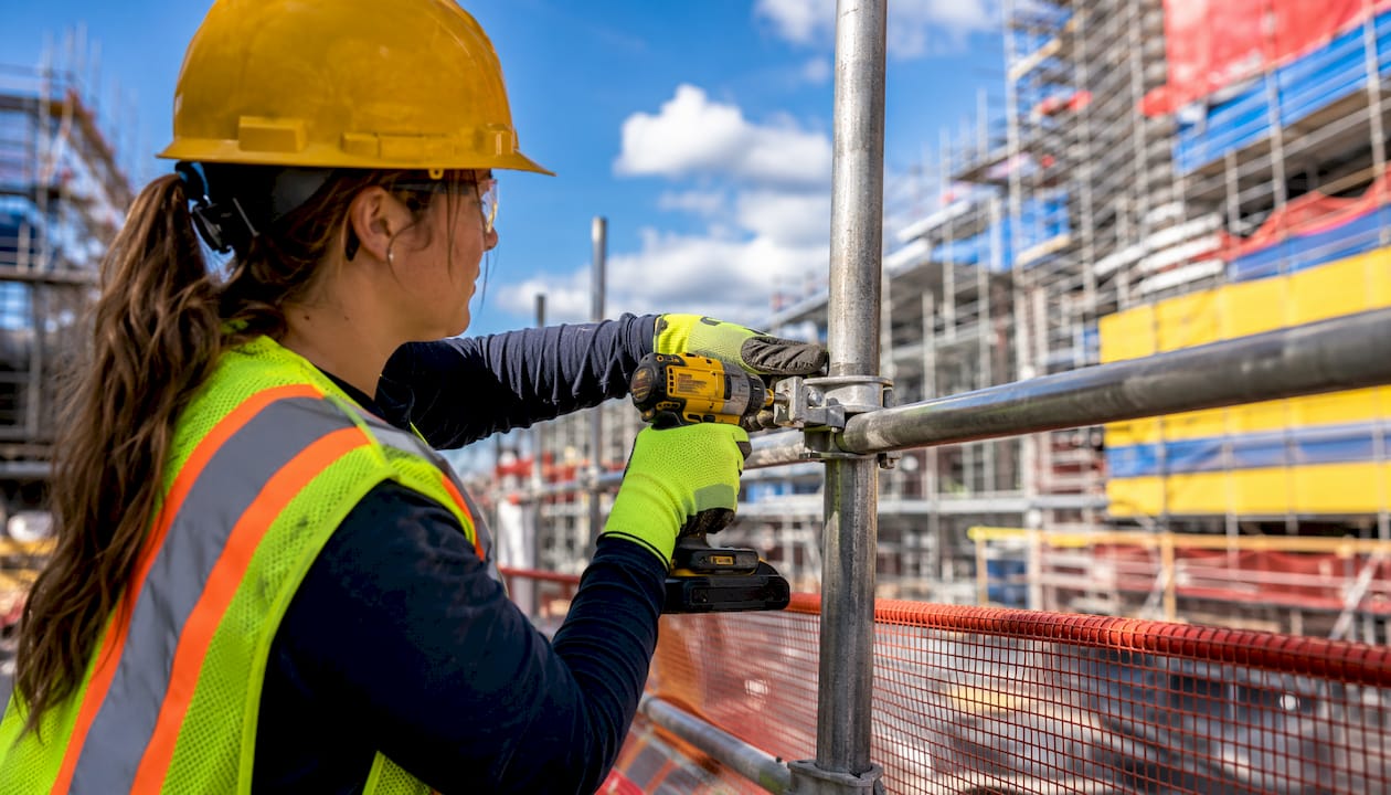 Hands installing scaffold fall protection guardrail