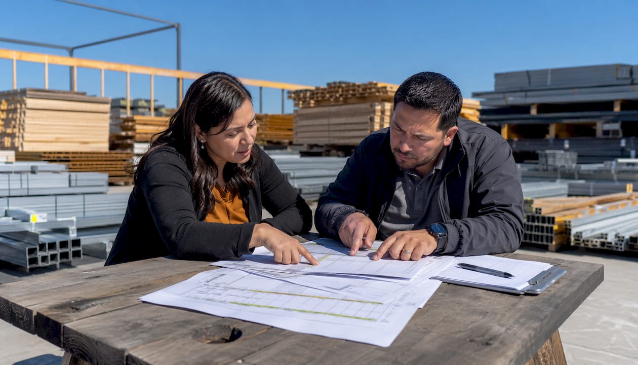 Hands reviewing construction material delivery