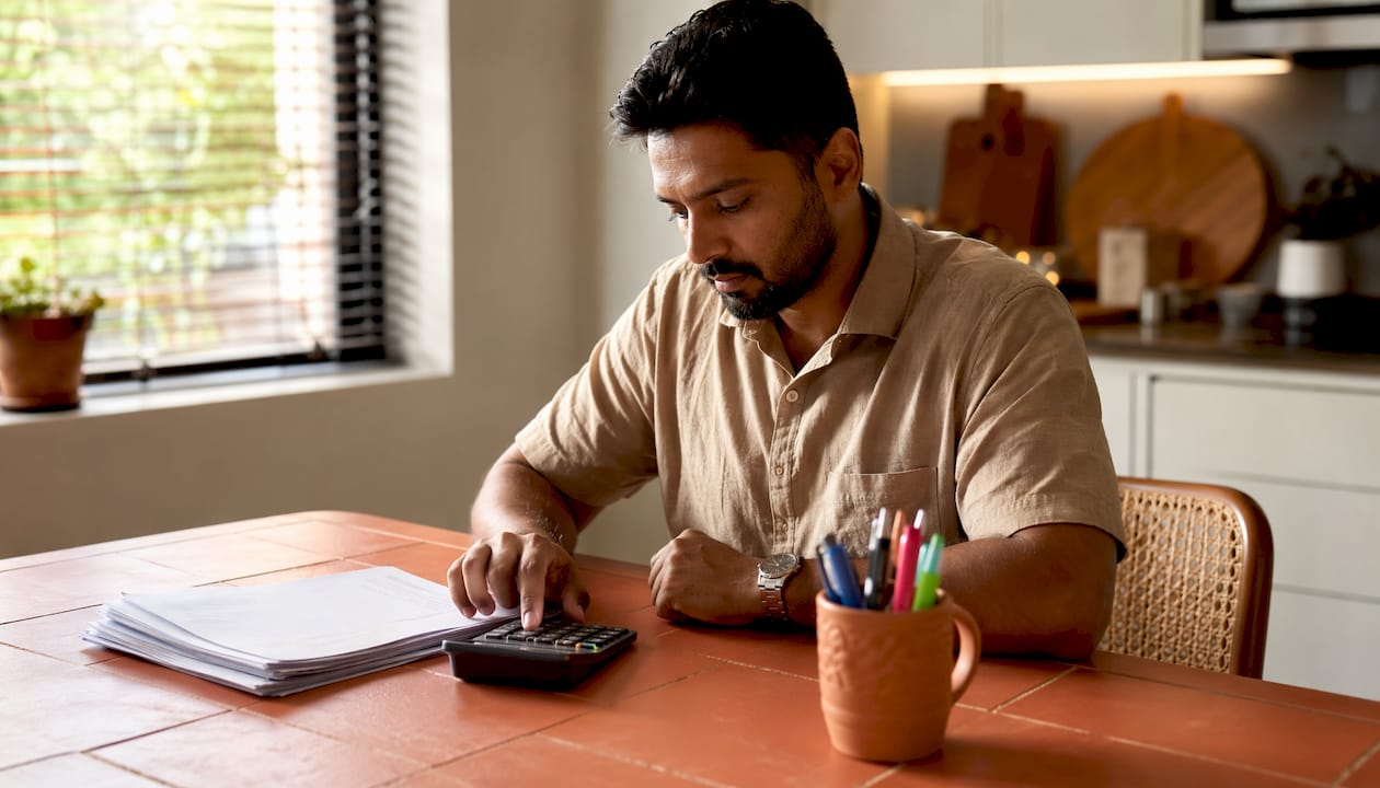Hands using calculator with mortgage credit guidelines