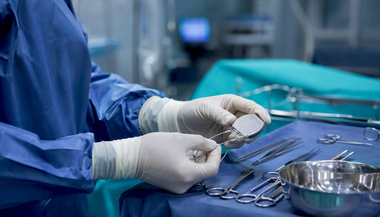 Surgeon preparing spinal cord stimulator implant