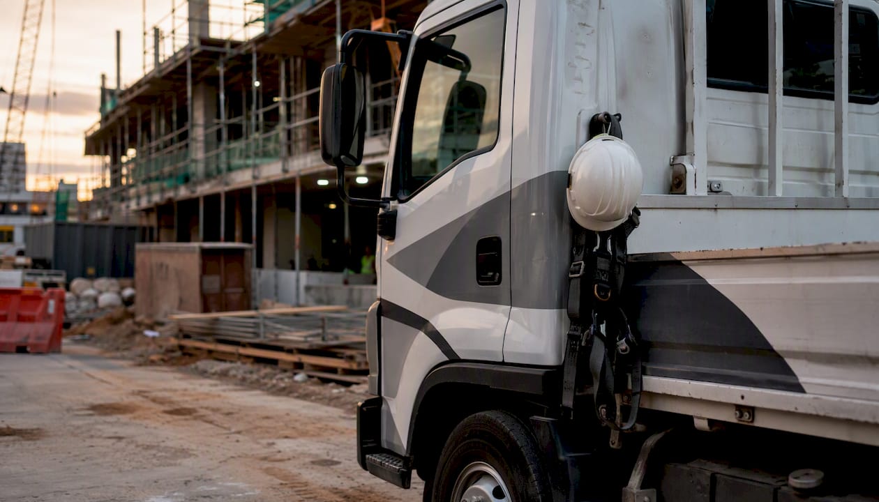 Construction truck with slogan wrap at site