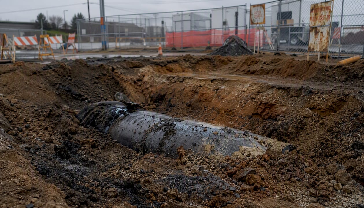Discolored soil and storage tank fragment