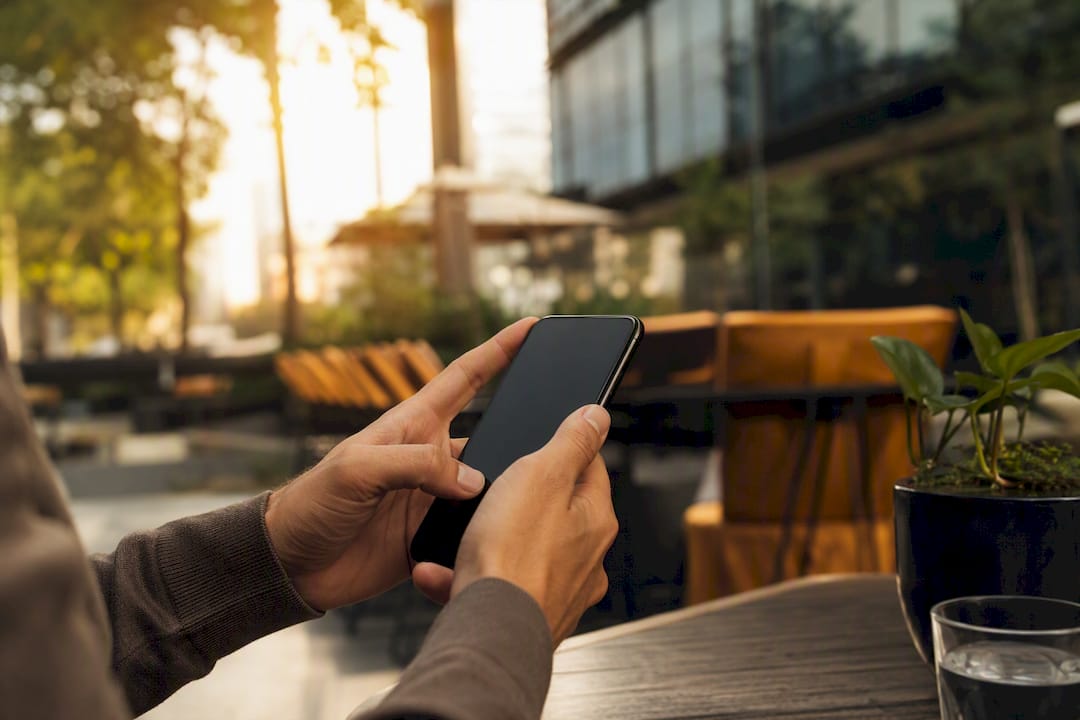Person’s hands holding smartphone for job search