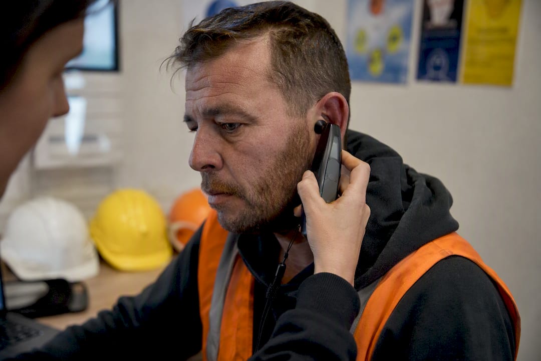 Construction worker undergoing hearing screening test