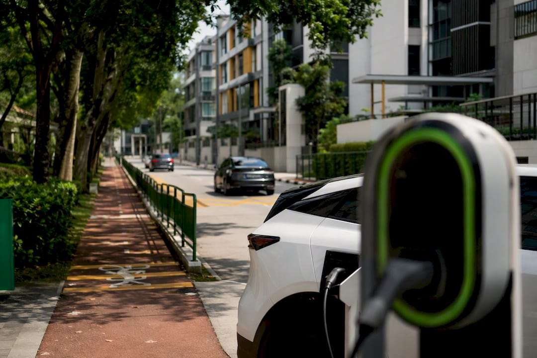 Quiet Singapore street with low-emission vehicles and pedestrians