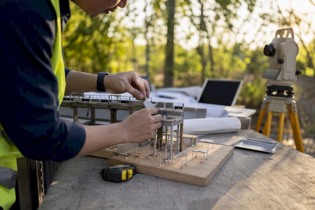 Engineer adjusting structural scale model