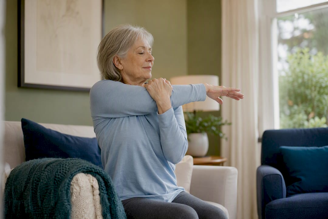 Senior performing arm stretch at home
