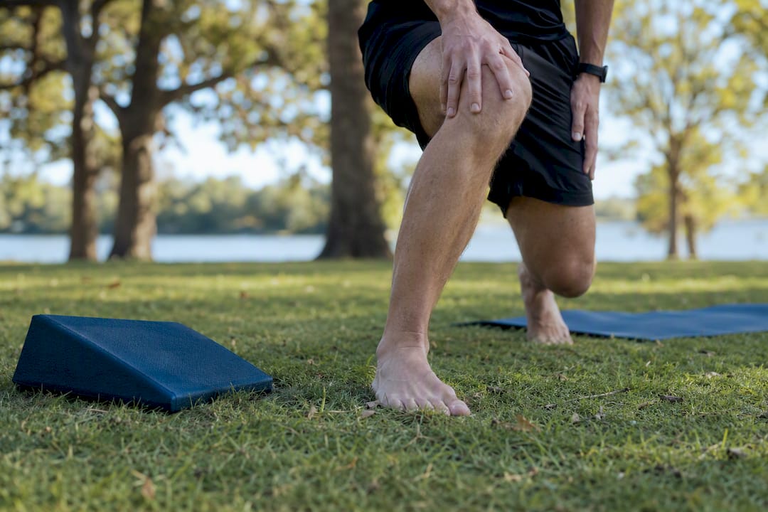 Close-up of ankle dorsiflexion stretch by wall