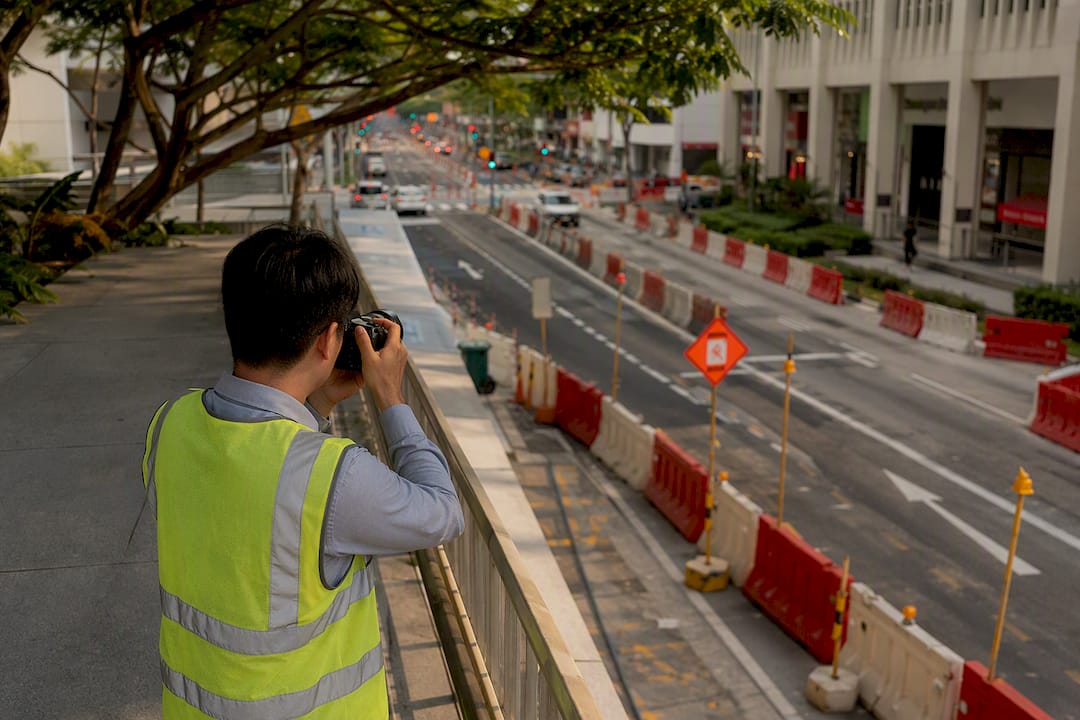 Engineer photographing road closure barricades onsite