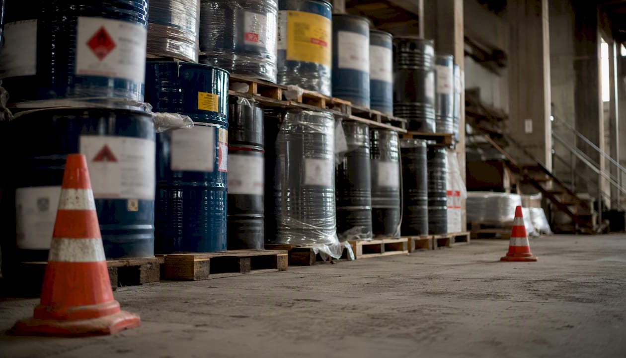 Imported chemical drums with multi-language labels in warehouse