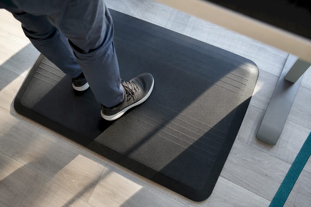 Shoes shifting weight on anti-fatigue mat