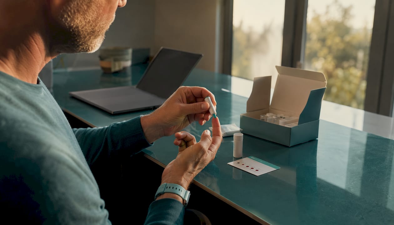 Hands collecting finger-prick blood sample