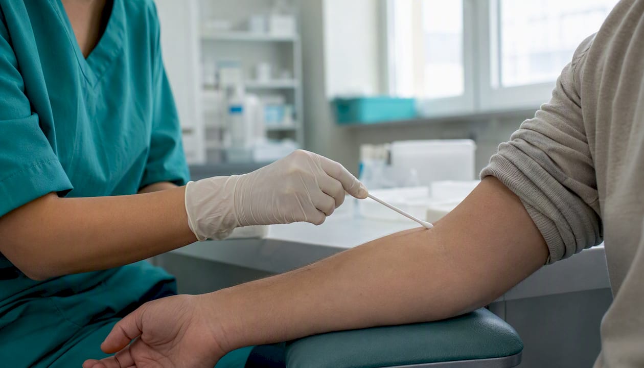 Gloved hands performing swab test