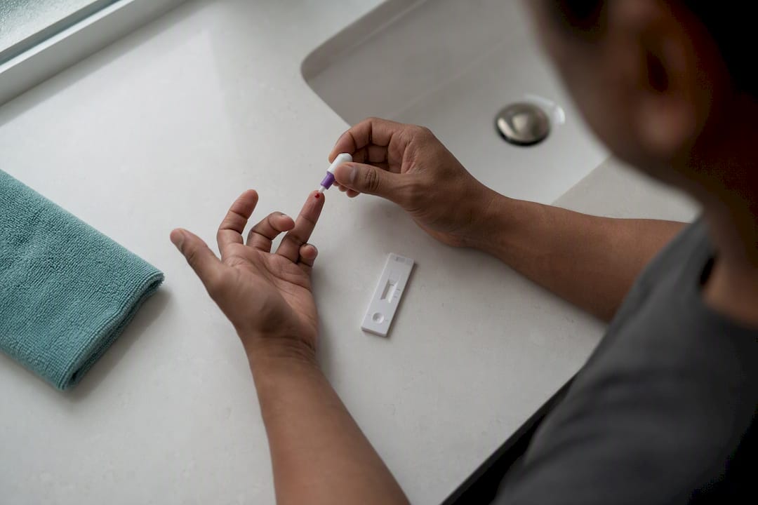 Finger prick blood sample collection on test strip