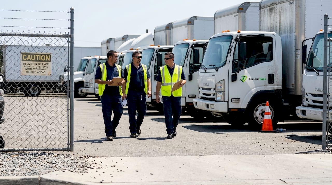 Fleet drivers walk across truck yard