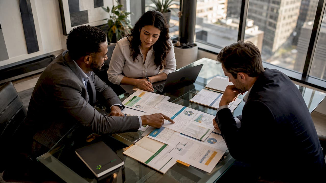 Insurance agents discussing agency alliance contracts