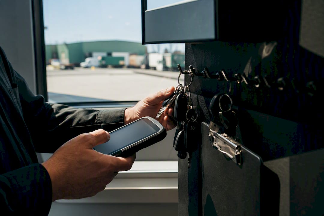 Hands holding keys at fleet dispatch depot