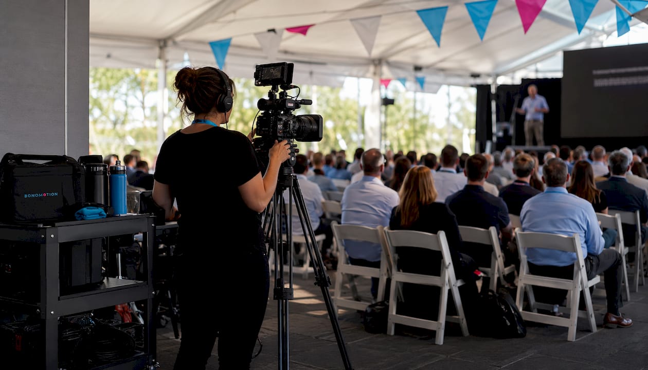 Event Videography Vs Photography: A Planner'S Guide 1 Videographer shooting corporate conference event