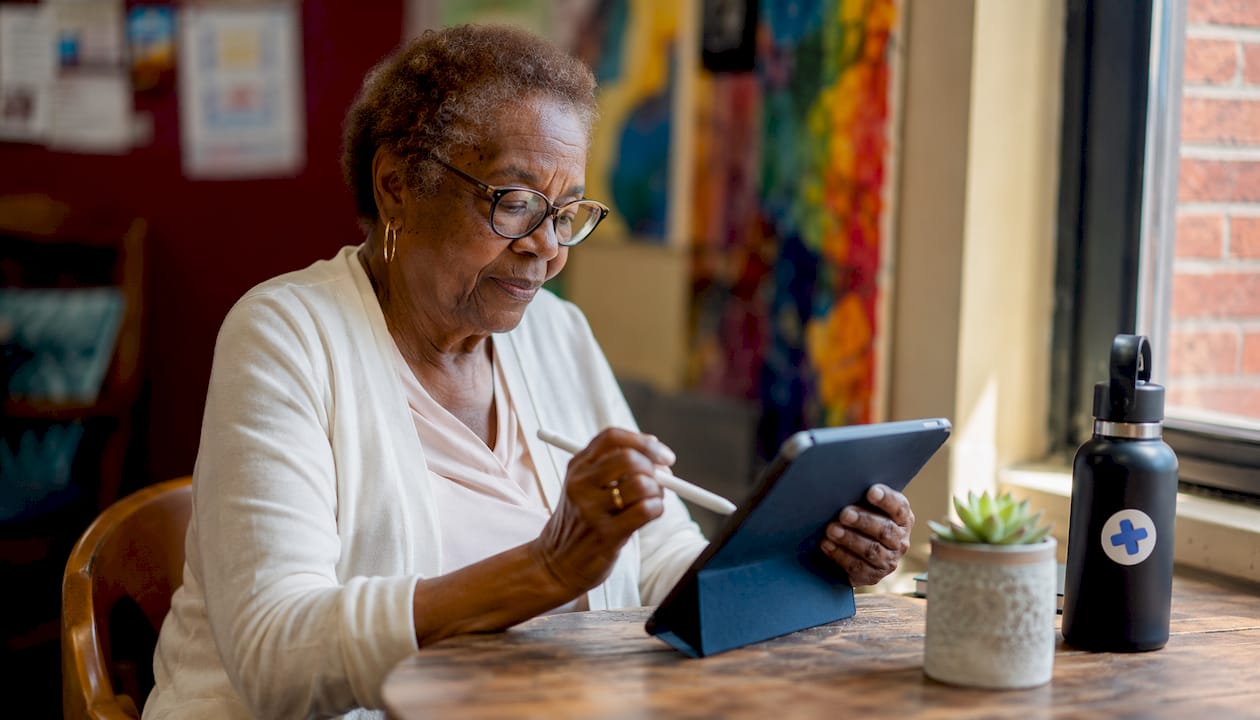 Hands using tablet for patient education app