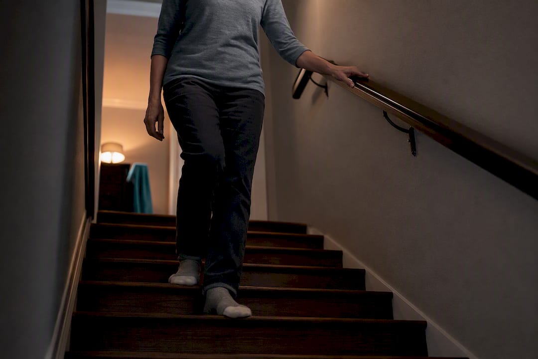 Person steadying themselves on stairs