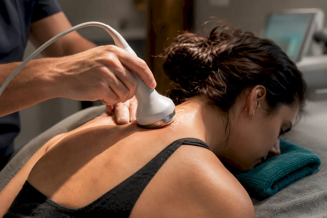 Clinician applying ultrasound neck therapy