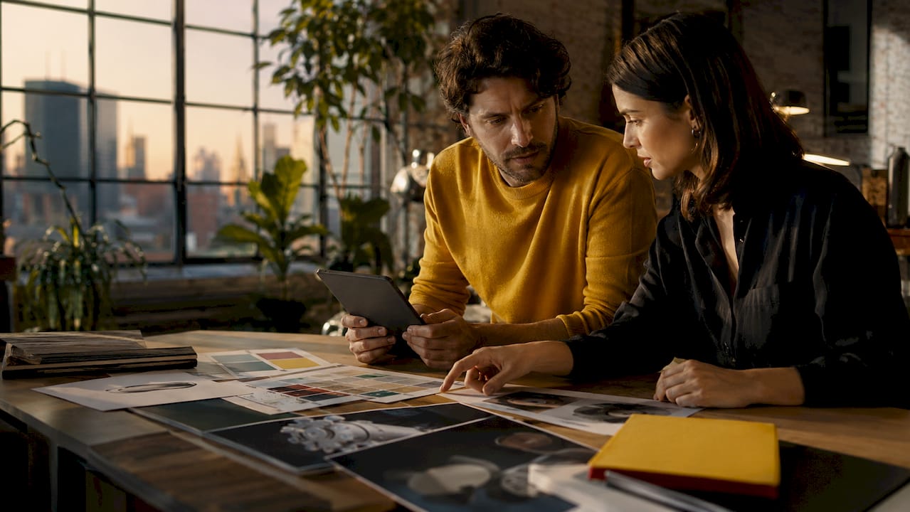 Professionals collaborating on CGI workflow at office table