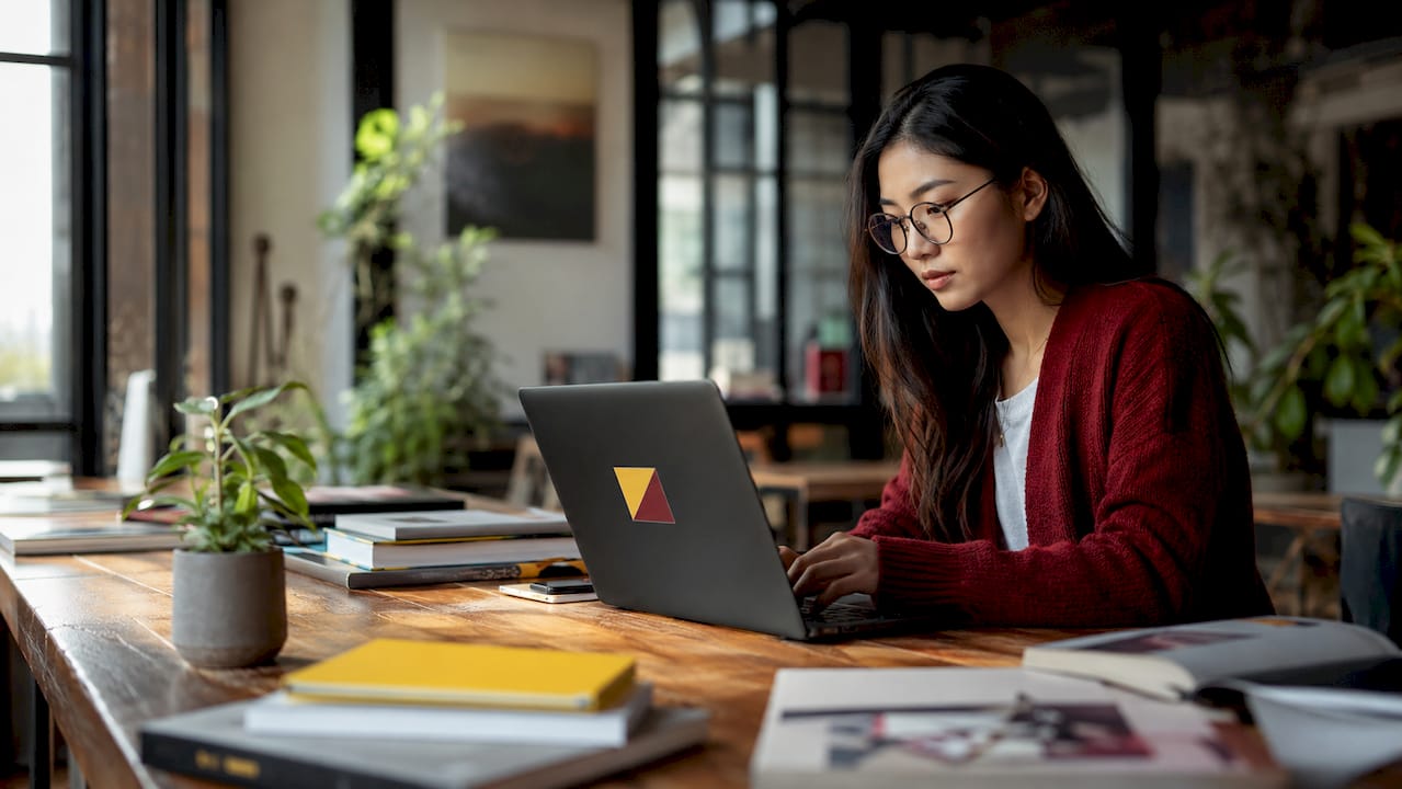 Startup founder editing images at coworking desk