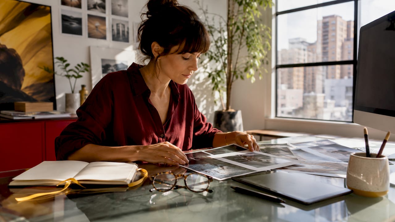 Creative professional reviewing prints and digital tools